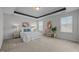 Spacious main bedroom with tray ceiling, two windows, and stylish decor at 1033 Laredo Ln, Durham, NC 27703