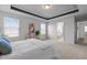 Bright main bedroom with tray ceiling, carpet, and access to an ensuite bathroom at 1033 Laredo Ln, Durham, NC 27703