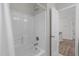 Bathroom shower with white tile and modern fixtures, next to a door at 1033 Laredo Ln, Durham, NC 27703