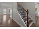 Staircase with wood treads, white risers, and ornate black metal spindles at 1033 Laredo Ln, Durham, NC 27703