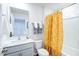Clean bathroom featuring modern fixtures, stylish lighting, and a bright shower curtain at 104 Red Maple St, Sanford, NC 27332