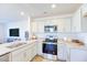 Kitchen features a stainless steel oven, granite counters, light cabinets, and wood flooring in a bright space at 104 Red Maple St, Sanford, NC 27332