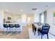 Well-lit open concept features a kitchen with a breakfast bar, dining space, and entrance hallway at 104 Red Maple St, Sanford, NC 27332