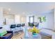 Open concept living space with kitchen, dining area, and living room, highlighted by bar seating and modern artwork at 104 Red Maple St, Sanford, NC 27332