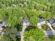 Aerial view showcases the houses nestled among mature trees, highlighting the neighborhood's peaceful, wooded setting at 105 Hein Dr, Clayton, NC 27527