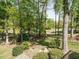 Picturesque backyard view featuring lush greenery, mature trees, and a glimpse of a golf course at 105 Hein Dr, Clayton, NC 27527
