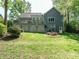 Expansive backyard with deck, fire pit, and lush green grass, perfect for outdoor entertaining and relaxation at 105 Hein Dr, Clayton, NC 27527