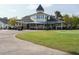 Elegant clubhouse with covered patio and golf carts, perfect for golf enthusiasts at 105 Hein Dr, Clayton, NC 27527