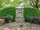 Stone monument sign with landscaping marking the entrance to The Neuse Golf Club Glen Laurel at 105 Hein Dr, Clayton, NC 27527