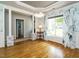 Dining room with hardwood floors, decorative wallpaper, and windows with a view of the outdoors at 105 Hein Dr, Clayton, NC 27527