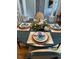 Stylish dining room with blue place settings and a decorative centerpiece on a round table at 105 Hein Dr, Clayton, NC 27527