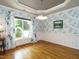 Light filled dining room with decorative wallpaper, hardwood floors, and a large window at 105 Hein Dr, Clayton, NC 27527