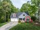Charming home featuring a two-car garage, beautiful landscaping, and a well-maintained lawn at 105 Hein Dr, Clayton, NC 27527