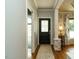 Bright hallway featuring a stylish front door and view into the decorated dining room at 105 Hein Dr, Clayton, NC 27527