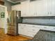 A kitchen featuring white cabinets, granite countertops, and stainless steel appliances at 105 Hein Dr, Clayton, NC 27527
