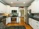 Bright kitchen featuring white cabinets, granite countertops, stainless steel appliances at 105 Hein Dr, Clayton, NC 27527