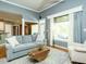 Cozy living room with large windows, hardwood floors, and a comfortable sofa at 105 Hein Dr, Clayton, NC 27527