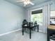 Home office with a sleek black desk, comfortable chair, and natural light from the window at 105 Hein Dr, Clayton, NC 27527