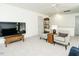 Light-filled sitting room offers cozy seating, entertainment center and neutral tones at 105 Hein Dr, Clayton, NC 27527