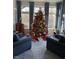Warm sunroom with comfortable seating, large windows for natural light, and a decorated Christmas tree at 105 Hein Dr, Clayton, NC 27527
