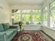 Bright sunroom with floor to ceiling windows, comfortable seating, and a view of the outdoor deck at 105 Hein Dr, Clayton, NC 27527