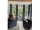 Inviting sunroom with comfortable seating, and large windows offering views of the trees at 105 Hein Dr, Clayton, NC 27527