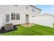 View of the backyard with a patio and lush grass surrounded by a white fence at 106 Red Maple St, Sanford, NC 27332