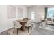 Dining area adjacent to the living room features contemporary decor, seating for six, and natural light at 106 Red Maple St, Sanford, NC 27332