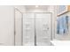 A bright walk-in shower with glass doors and built-in shelving at 106 Red Maple St, Sanford, NC 27332