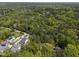 Wide aerial view featuring various homes surrounded by a dense forest, highlighting a serene community at 107 Deer St, Carrboro, NC 27510