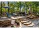 Backyard patio featuring comfortable seating, a shade umbrella, and an outdoor gas heater at 107 Deer St, Carrboro, NC 27510
