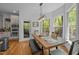Bright dining area features a rustic wooden table and large windows with views of the surrounding greenery at 107 Deer St, Carrboro, NC 27510