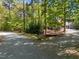 Scenic home entrance with a gravel driveway, mature trees, and landscaped gardens offering a tranquil setting at 107 Deer St, Carrboro, NC 27510