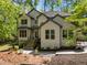 Beautiful two-story home boasts manicured landscaping, a welcoming entrance, and a charming facade, nestled among mature trees at 107 Deer St, Carrboro, NC 27510