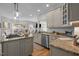Modern kitchen with granite counters, stainless appliances, and an open layout flowing into the dining and living areas at 107 Deer St, Carrboro, NC 27510