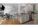 Open-concept kitchen flows into the living room, featuring granite countertops, and stainless steel appliances for modern living at 107 Deer St, Carrboro, NC 27510