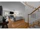 Bright living room with hardwood floors, fireplace, large windows, and an open floor plan with modern decor and a staircase at 107 Deer St, Carrboro, NC 27510