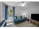 Cozy living room with natural light, a comfortable couch, and music instruments at 107 Deer St, Carrboro, NC 27510