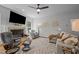 Cozy living room features a fireplace, a ceiling fan, and plush seating with a view of the backyard at 107 Deer St, Carrboro, NC 27510