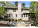 A view of the back of the house that features a beige exterior, large chimney, and deck at 107 Deer St, Carrboro, NC 27510