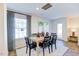Bright dining area featuring modern light fixtures, a wooden table, and elegant curtains at 108 Red Maple St, Sanford, NC 27332