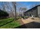 Secluded backyard with mature trees, fire pit, deck, and outdoor seating at 10805 The Olde Pl, Raleigh, NC 27614