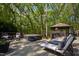 Enjoy the spacious backyard deck with a relaxing hot tub, lounge chairs, and peaceful outdoor seating at 10805 The Olde Pl, Raleigh, NC 27614