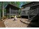 Charming backyard patio with covered picnic area, steps to seating, and lush surroundings for a serene retreat at 10805 The Olde Pl, Raleigh, NC 27614