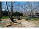 Landscaped backyard with stone patio, fire pit, and seating, perfect for relaxing or entertaining at 10805 The Olde Pl, Raleigh, NC 27614