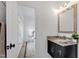 Elegant bathroom with a vanity featuring a granite countertop and dark wood cabinetry, next to the bedroom at 10805 The Olde Pl, Raleigh, NC 27614