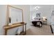 Inviting bedroom featuring light walls, carpet, with stylish furnishings and a decorative entryway table at 10805 The Olde Pl, Raleigh, NC 27614