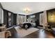 Stylish bedroom features dark accent walls, hardwood floors, and a cozy seating area near the window at 10805 The Olde Pl, Raleigh, NC 27614
