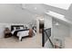 Inviting bedroom with stairs, carpeted floors, a ceiling fan, and access to a walk-in closet at 10805 The Olde Pl, Raleigh, NC 27614
