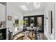 Breakfast nook features skylights, a round table, and views of the outdoor deck and backyard at 10805 The Olde Pl, Raleigh, NC 27614